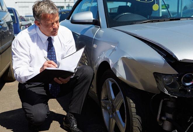 green car parked with insurance coverage displayed